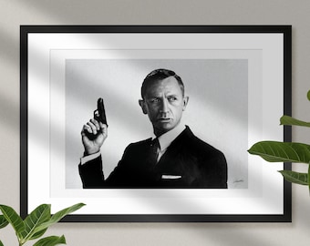 May include: Black and white portrait of a man in a suit holding a gun. The man is looking directly at the camera with a serious expression. The background is a plain white wall.