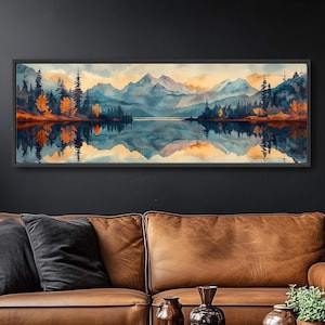 May include: A panoramic watercolor painting of a mountain lake scene. The painting features a lake reflecting the surrounding mountains, trees, and sky. The water is a deep blue, and the mountains are a soft purple and blue. The trees are a mix of green and orange, and the sky is a light blue with clouds.