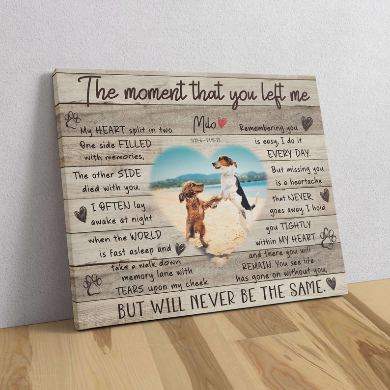 May include: A wooden canvas print with a photo of two dogs on a beach. The print features a heartfelt message about remembering a loved one who has passed away. The text reads "The moment that you left me... My heart split in two... One side filled with memories... The other side died with you... I often lay awake at night when the world is fast asleep and take a walk down memory lane with tears upon my cheek. But will never be the same."