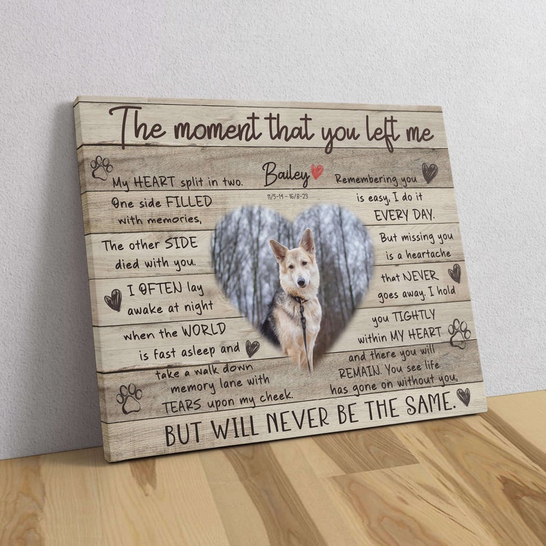 May include: A wooden canvas print with a heart-shaped photo of a dog in a forest. The print features a poem about remembering a pet who has passed away. The poem reads, "The moment that you left me, My heart split in two. One side filled with memories, The other side died with you. I often lay awake at night when the world is fast asleep and take a walk down memory lane with tears upon my cheek. But will never be the same."