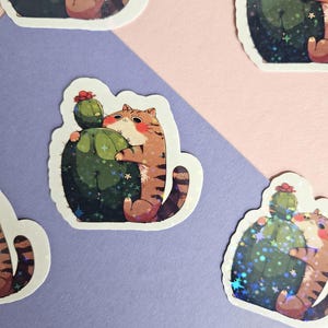 Pegatina de gato abrazando un cactus: vinilo adorable para amantes de los gatos