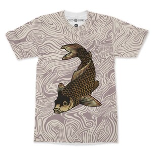 May include: A white V-neck t-shirt featuring a brown and gold koi carp design. The shirt has a light purple and white swirling pattern background. The text "SACRED SURREAL" is printed on the collar.