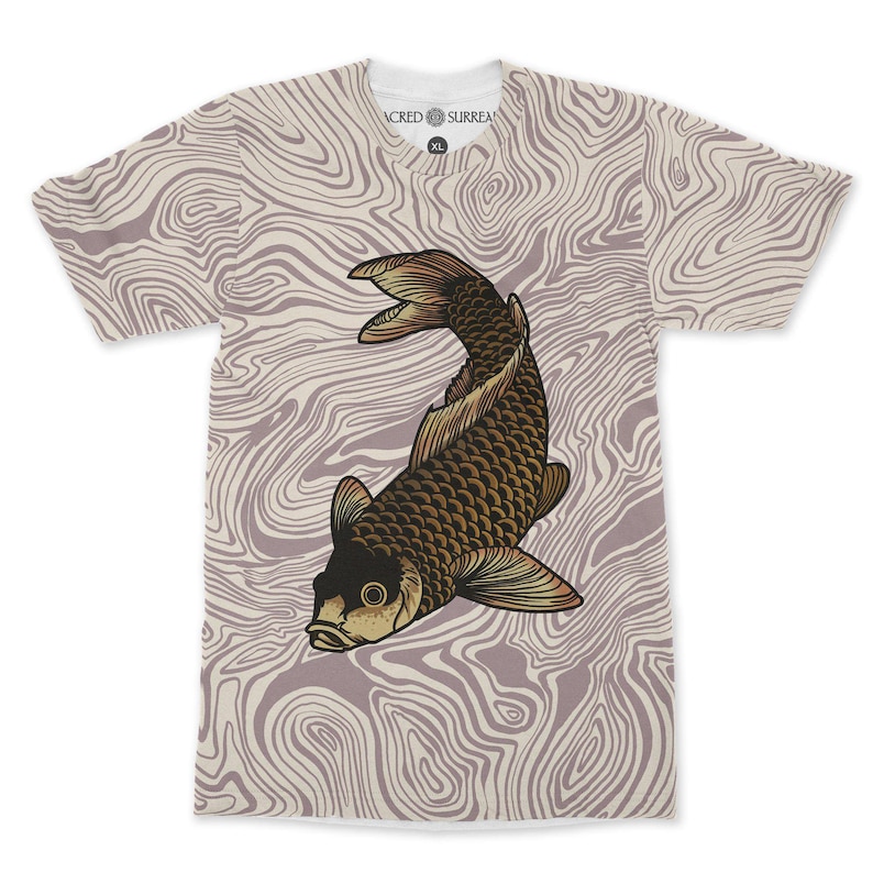 May include: A white V-neck t-shirt featuring a brown and gold koi carp design. The shirt has a light purple and white swirling pattern background. The text "SACRED SURREAL" is printed on the collar.