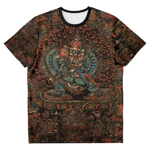 May include: Crew neck t-shirt with a detailed, colorful graphic print. The design features a deity with multiple arms and a fierce expression, set against a dark background with intricate patterns. The shirt has a black collar and a white interior.