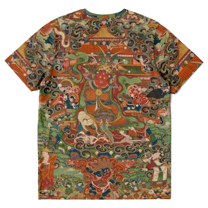 May include: A short-sleeved t-shirt featuring a detailed, colorful illustration. The artwork depicts a central figure with a red face, surrounded by other figures, buildings, and swirling patterns. The design is printed across the entire shirt.