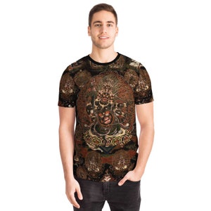 May include: A black crew neck t-shirt with a detailed, multi-coloured illustration of a deity. The artwork includes shades of red, brown, and gold, with intricate details and a dark background. The shirt is worn by a person.