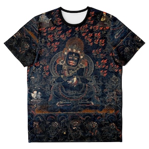 May include: A short-sleeved t-shirt featuring a detailed, dark blue illustration of a deity with a fierce expression. The artwork includes red and gold accents, with a black collar and a white inner neckline. The design is intricate and covers the entire shirt.