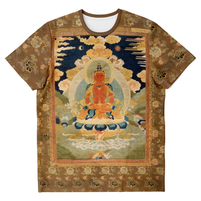 May include: A short-sleeved t-shirt featuring a detailed, colorful illustration of a seated figure with a halo, set against a backdrop of clouds and a night sky. The shirt has a brown collar and floral patterned sleeves and borders.
