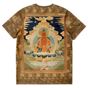 May include: Brown t-shirt featuring a detailed illustration of a seated figure with a halo, set against a backdrop of clouds and a night sky. The shirt has a brown collar and sleeves with a floral pattern.
