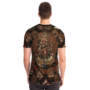 May include: A short-sleeved t-shirt with a detailed, colourful illustration of a deity with multiple arms and a fierce expression. The artwork is set against a dark background with additional figures, creating a complex and ornate design.