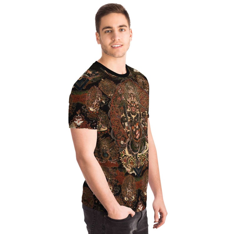 May include: A short-sleeved t-shirt with an elaborate pattern in brown, red, and gold on a black backdrop. The design is intricate and covers the entire shirt. The t-shirt has a crew neck. The overall effect is of a detailed and artistic garment.