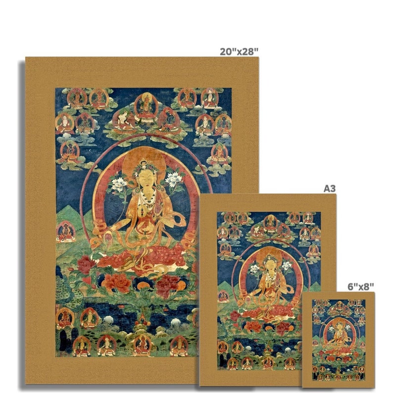May include: A colorful Tibetan Buddhist Thangka painting depicting a deity, possibly a female Buddha, seated in a lotus position. The deity is surrounded by smaller figures and symbols, all set against a blue background. The painting is framed in a gold-colored border.