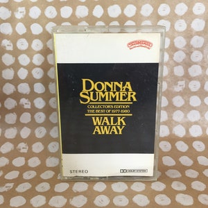 May include: A cassette tape with a black and white label. The label says "Donna Summer, Collector's Edition, The Best of 1977-1980, Walk Away". The cassette tape is in a clear plastic case.