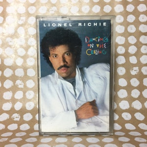 May include: A cassette tape with a photo of Lionel Richie on the cover. The title of the album is "Dancing on the Ceiling".