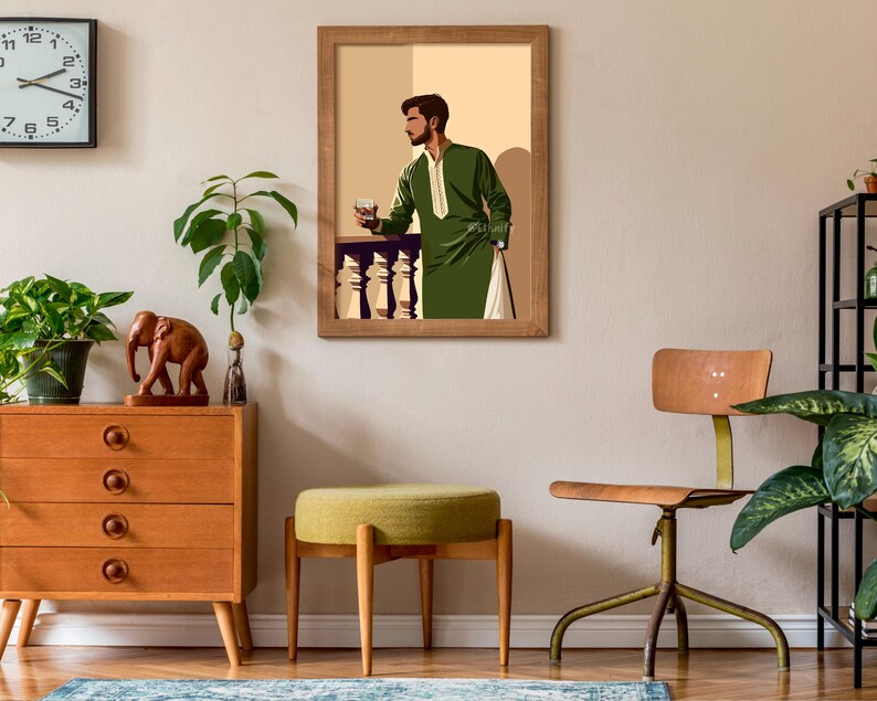 May include: A framed illustration of a man in a green robe holding a glass of liquid. The illustration is set against a beige background. The frame is brown wood with a white mat.