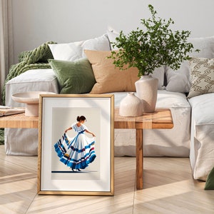 May include: A framed print featuring a stylized illustration of a woman in a traditional white dress with blue and red accents. The artwork is displayed on a wooden table, with a neutral background and a gold frame. The scene is set in a well-lit, modern living space.