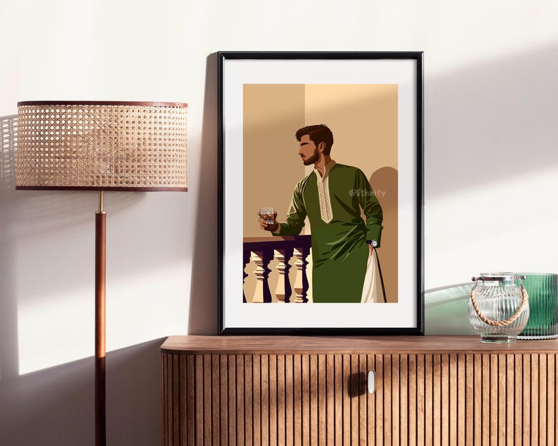 May include: A framed illustration of a man in a green long-sleeved shirt and pants standing on a balcony, holding a glass of liquid. The background is a light beige color.