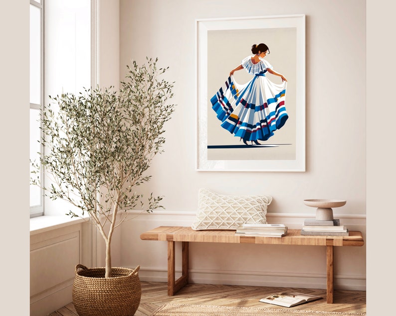 May include: Framed art print featuring a stylized illustration of a woman in a traditional white dress with blue and red accents. The artwork is displayed in a bright, airy room with a wooden bench, a woven basket, and a potted plant.