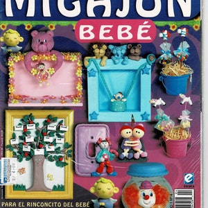 Puede incluir: Una portada de revista con una ilustración colorida de un proyecto de manualidades con temática de bebé. El título de la revista es "MIGAJO'N BEBE" y la portada presenta una variedad de manualidades, incluyendo un marco de fotos, una tapa de interruptor de luz y un frasco con una cara de payaso. La revista se titula "Artes Manuales" y forma parte de la colección "Centauro".