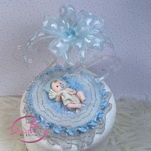Baby laying on blanket baby shower cake topper, hand made in cold porcelain