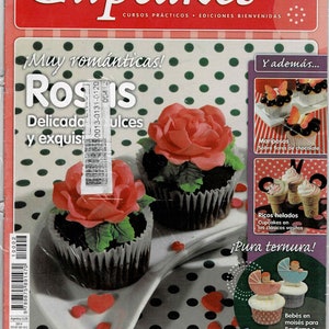 May include: A magazine cover featuring cupcakes decorated with roses, butterflies, and ice cream. The magazine is titled "Cupcakes" and has the words "Muy romanticas! Rosis" on the cover. The magazine is part of a collection of four monthly issues.