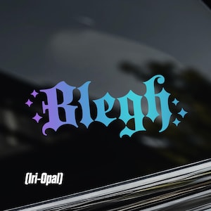 May include: A vinyl decal sticker applied to a car window featuring the word Blegh in a stylised gothic font. The lettering displays a gradient colour transition from purple to blue to teal, accented by small four-pointed star shapes on each side.