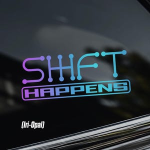 May include: A decal applied to a dark window featuring the text SHIFT HAPPENS in a gradient of purple, blue, and teal. The word SHIFT is stylised with circular nodes at the letter terminals, while HAPPENS is in a block font inside a rectangular outline.