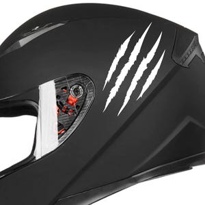 May include: Black motorcycle helmet with white claw marks decals on the side.