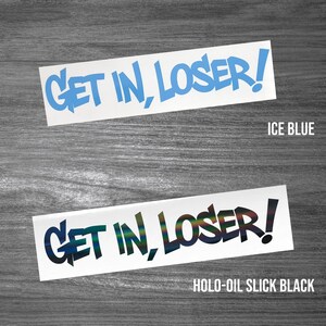 May include: Two rectangular vinyl decals featuring the text GET IN, LOSER! in a bold, jagged font. The top decal is ice blue, and the bottom decal is a holographic oil slick black finish. Both stickers are presented on a white background.