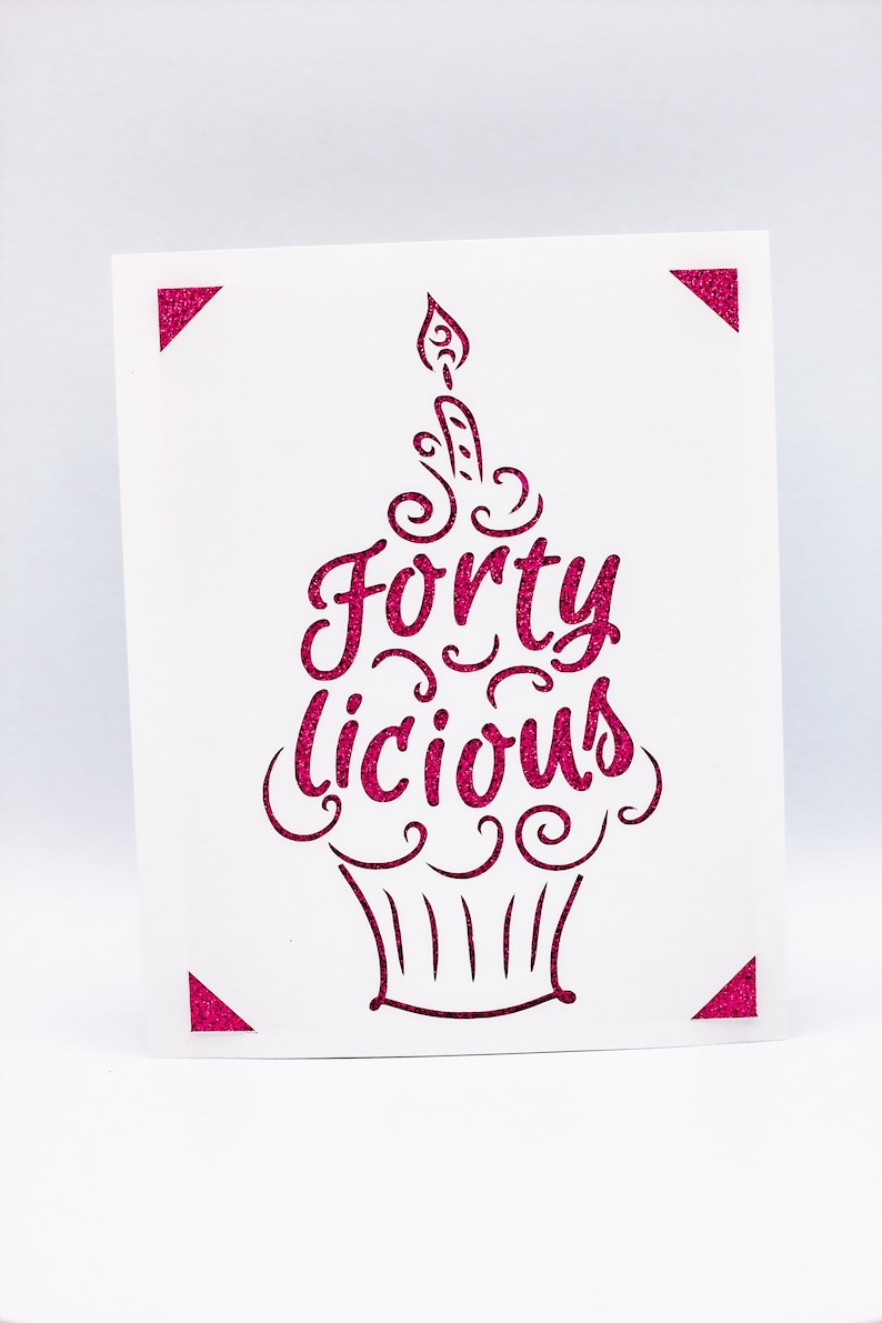 May include: A pink glitter card with a cupcake design and the text "Fortylicious".