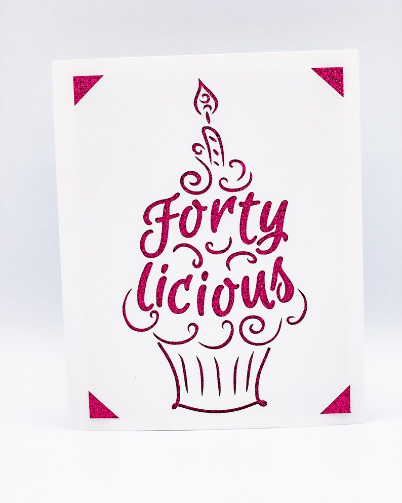 May include: Pink glitter card with a cupcake design and the text "Forty Licious".