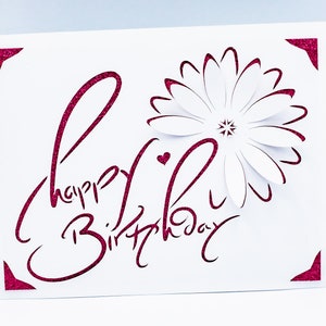 May include: A white card with a pink glitter design that says "Happy Birthday" with a pink glitter flower in the corner.