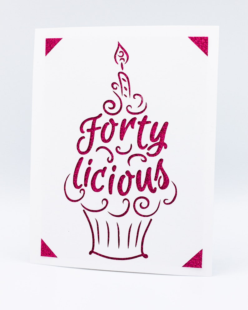 May include: A pink glitter card with a cupcake design and the text "Forty Licious".