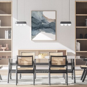 May include: A dining room with a glass table and six black chairs with woven cane seats. The table is set with a bowl of fruit. There are two bookshelves on either side of the table, and a large abstract painting on the wall behind the table.