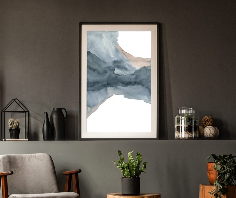 May include: A framed abstract watercolour painting with shades of blue and brown. The painting is on a white background and is framed in a black frame.