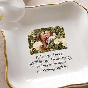 May include: A square white ceramic trinket dish with a gold-painted scalloped rim. The center features a color photograph of a person kissing a child among white roses, with the text: I'll love you forever. I'll like you for always. As long as I'm living my Mommy you'll be.
