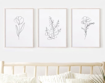 May include: Three black and white line drawings of flowers and foliage in simple frames. The frames are white with a thin wood-like border. The drawings are of a single flower, a sprig of eucalyptus, and a single flower with a stem.