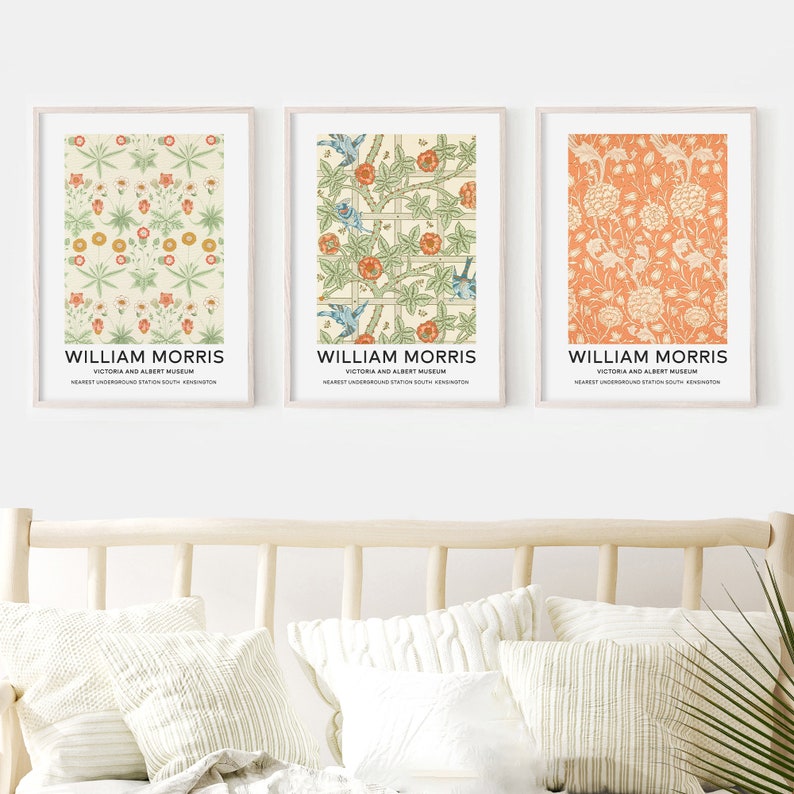 May include: Three framed prints of William Morris floral patterns. The prints are in a light wood frame and have a white background. The patterns are in shades of green, orange, and blue.