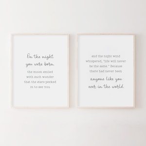 May include: Two framed prints with white backgrounds and black text. The left print reads "On the night you were born. The moon smiled with such wonder that the stars peeked in to see you." The right print reads "And the night wind whispered, "Life will never be the same." Because there had never been anyone like you ever in the world."