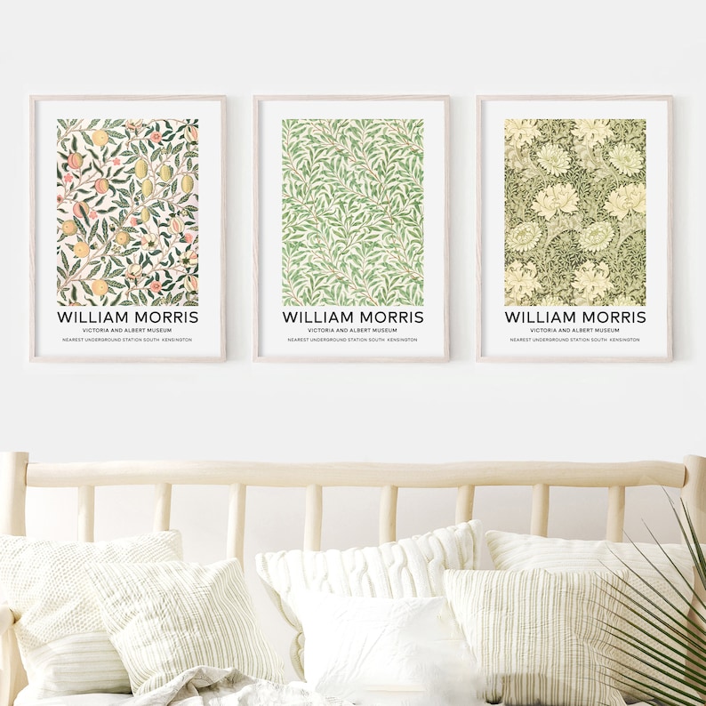 May include: Three framed prints of William Morris floral patterns. The prints are in a light wood frame and feature a green and white floral pattern, a green and white leaf pattern, and a yellow and green floral pattern. The prints are hung on a white wall.