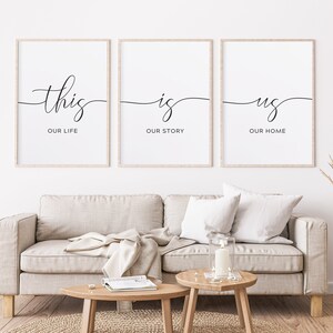 May include: Three black and white framed prints with the text "this is us" and the words "our life", "our story", and "our home" underneath each word.