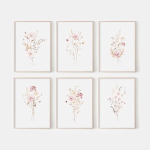 May include: Set of six watercolour floral prints featuring delicate pink and white flowers with brown stems and leaves. The prints are framed in a light wood frame and are perfect for adding a touch of nature to any room.