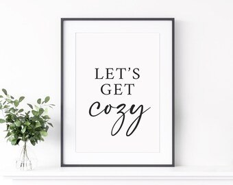 May include: Black and white printable wall art with the text "Let's Get Cozy" in a modern calligraphy font.