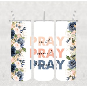 May include: White tumbler with the words "PRAY on it, over it, through it" in peach and navy blue. The tumbler features a floral design with navy, peach, and gold accents. Includes a silver straw.