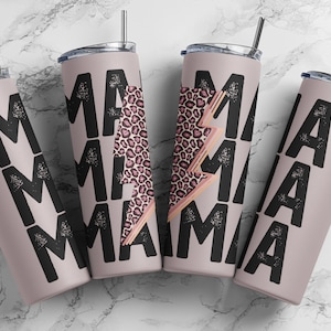 May include: Four pink insulated tumblers with black text that reads "MAMA". One tumbler features a pink and brown leopard print lightning bolt design. Each tumbler has a silver lid and a black straw.