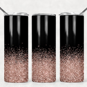 May include: Three black stainless steel tumblers with a rose gold glitter ombre design. The tumblers have a lid and a straw.