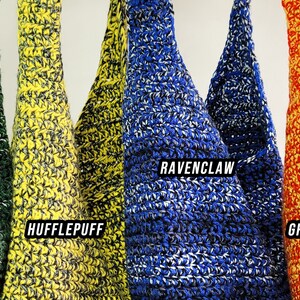 May include: Crocheted tote bags in green, yellow, blue, and red, each with a white accent. The bags are labeled with the names "Slytherin," "Hufflepuff," "Ravenclaw," and "Gryffindor" in white text, representing different houses.