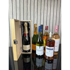May include: A wooden gift box with a selection of bottles of wine and liquor. The box contains a bottle of Mo&euml;t & Chandon champagne, a bottle of Mission Hill wine, a bottle of Martell cognac, a bottle of red wine, and a bottle of ros&eacute; wine.