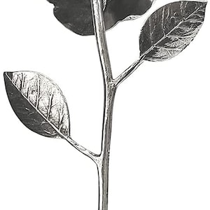 May include: A silver metal flower sculpture with a single bloom and leaves. The flower is facing down and the stem is long and slender.