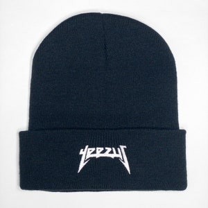 May include: Black beanie with a white "YEEZY" logo embroidered on the front.